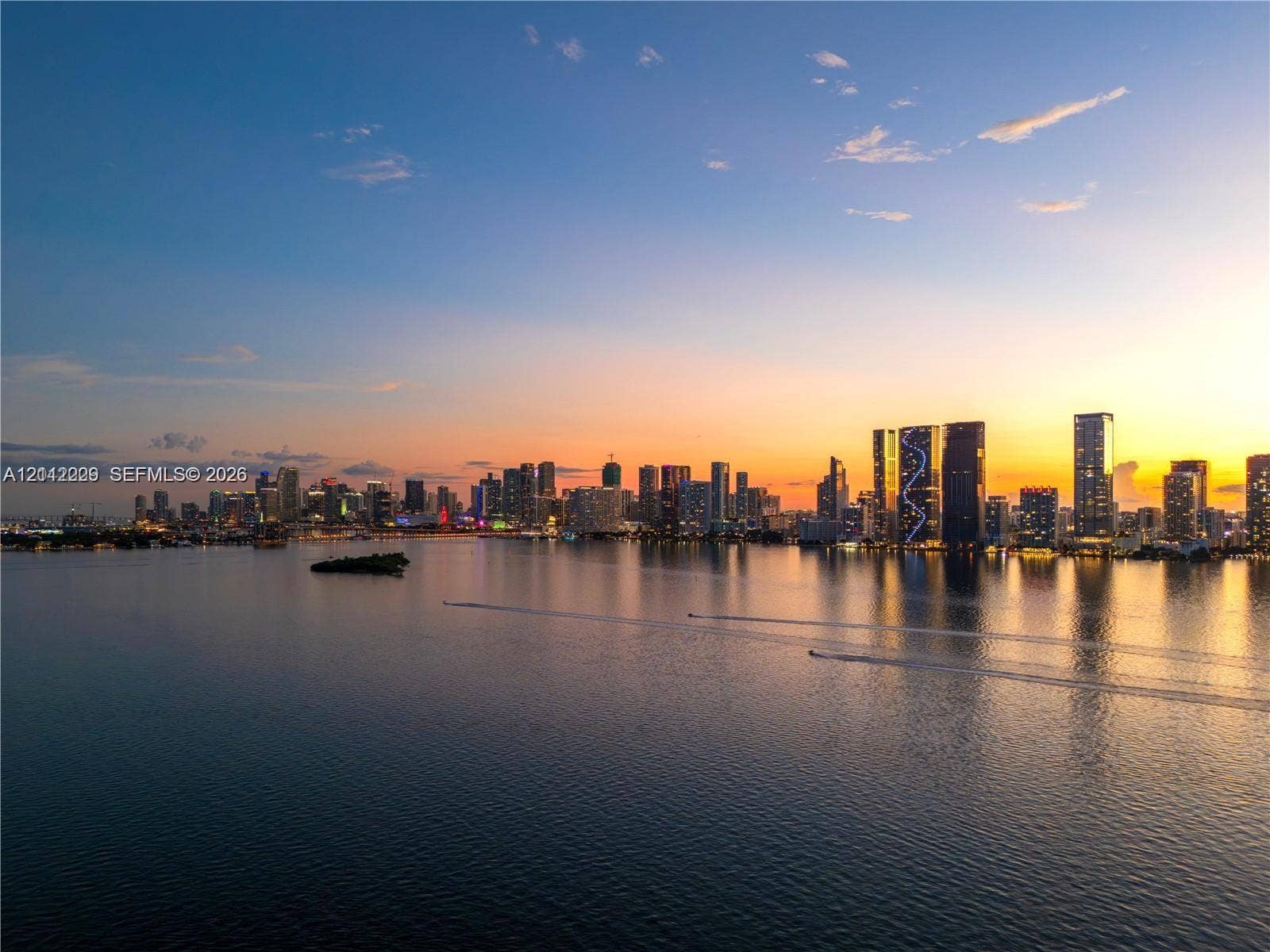 725 NE 24th Street, #706, Miami, Miami, FL 33137 Panoramic water expanse showcasing a multifaceted city skyline at dusk
