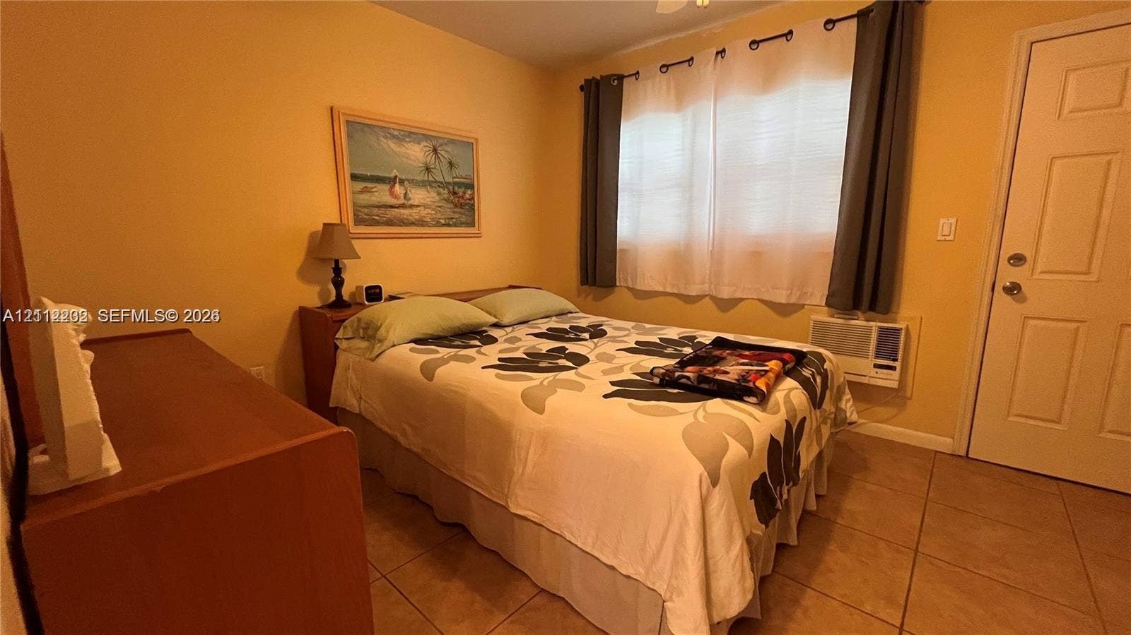 2001 S Ocean Drive, #55, Hallandale Beach, Hallandale Beach, FL 33009 Room featuring tile flooring, a wall-mounted cooling unit, and a paneled exterior door