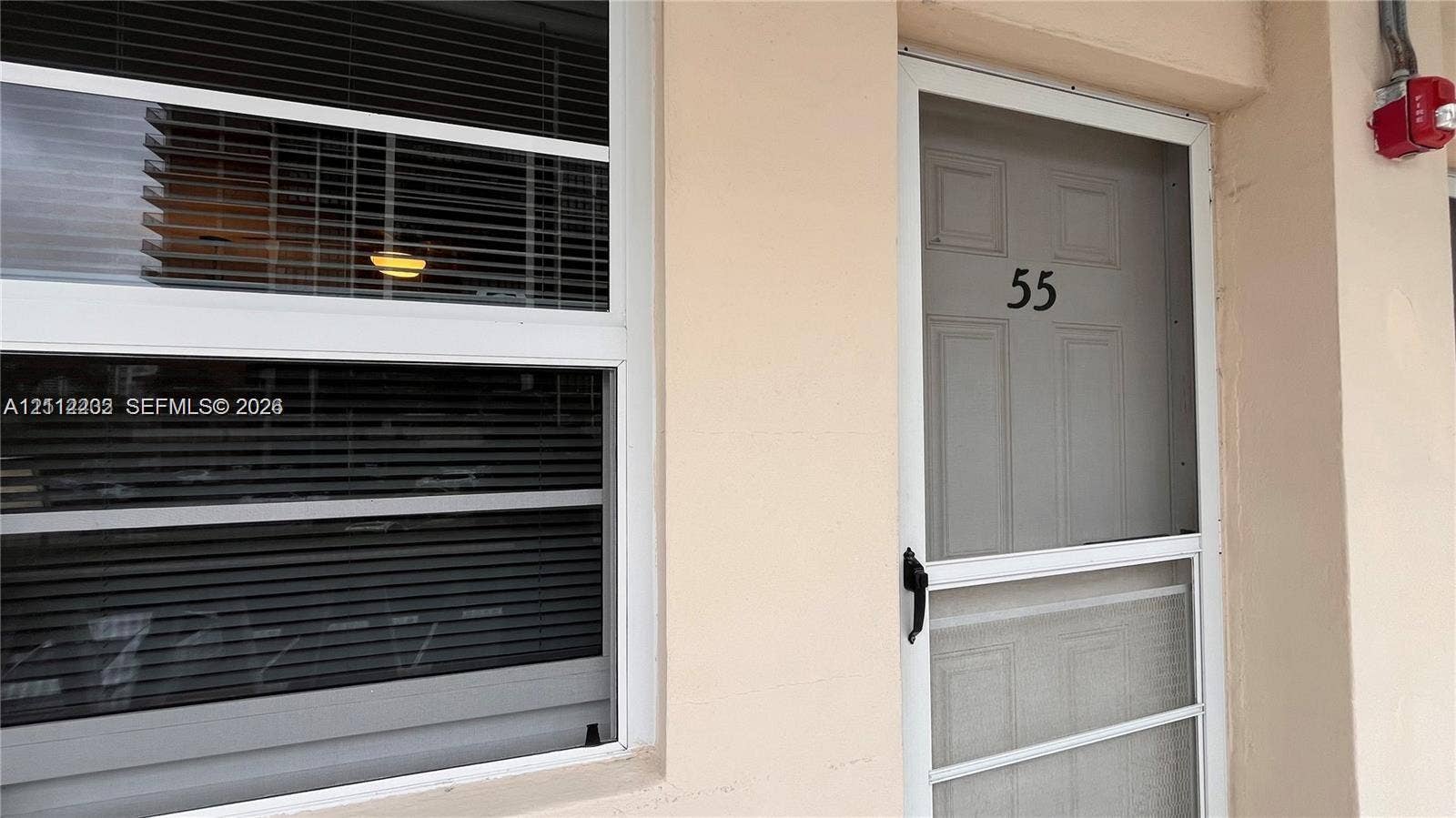 2001 S Ocean Drive, #55, Hallandale Beach, Hallandale Beach, FL 33009 Exterior entry featuring a white-framed storm door and a window with integrated horizontal blinds