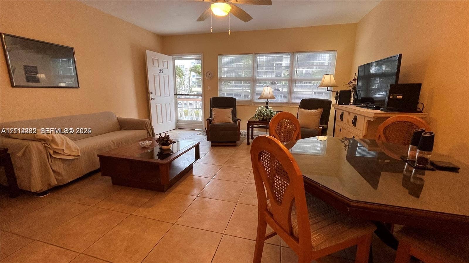 2001 S Ocean Drive, #55, Hallandale Beach, Hallandale Beach, FL 33009 Neutral tile flooring, multiple windows providing natural illumination, ceiling fan, and entry door with screen