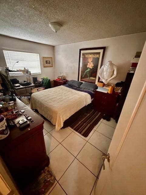 820 Salzedo Street, #305, Coral Gables, FL 33134 Neutral-toned ceramic tile flooring, horizontal window blinds, and a flush-mount ceiling light fixture