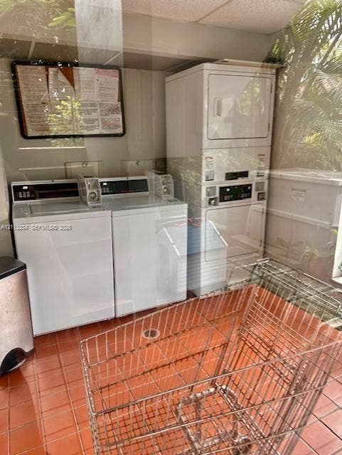 820 Salzedo Street, #305, Coral Gables, FL 33134 Laundry facility featuring two top-load washing machines and a stacked dryer unit, complemented by ceramic tile flooring