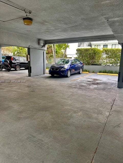 820 Salzedo Street, #305, Coral Gables, FL 33134 Covered parking area featuring concrete flooring, structural pillars, and designated parking stalls