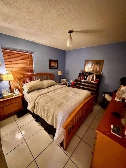 820 Salzedo Street, #305, Coral Gables, FL 33134 Room with light-colored tile flooring, neutral wall tones, window featuring horizontal blinds, and a centered pendant light fixture