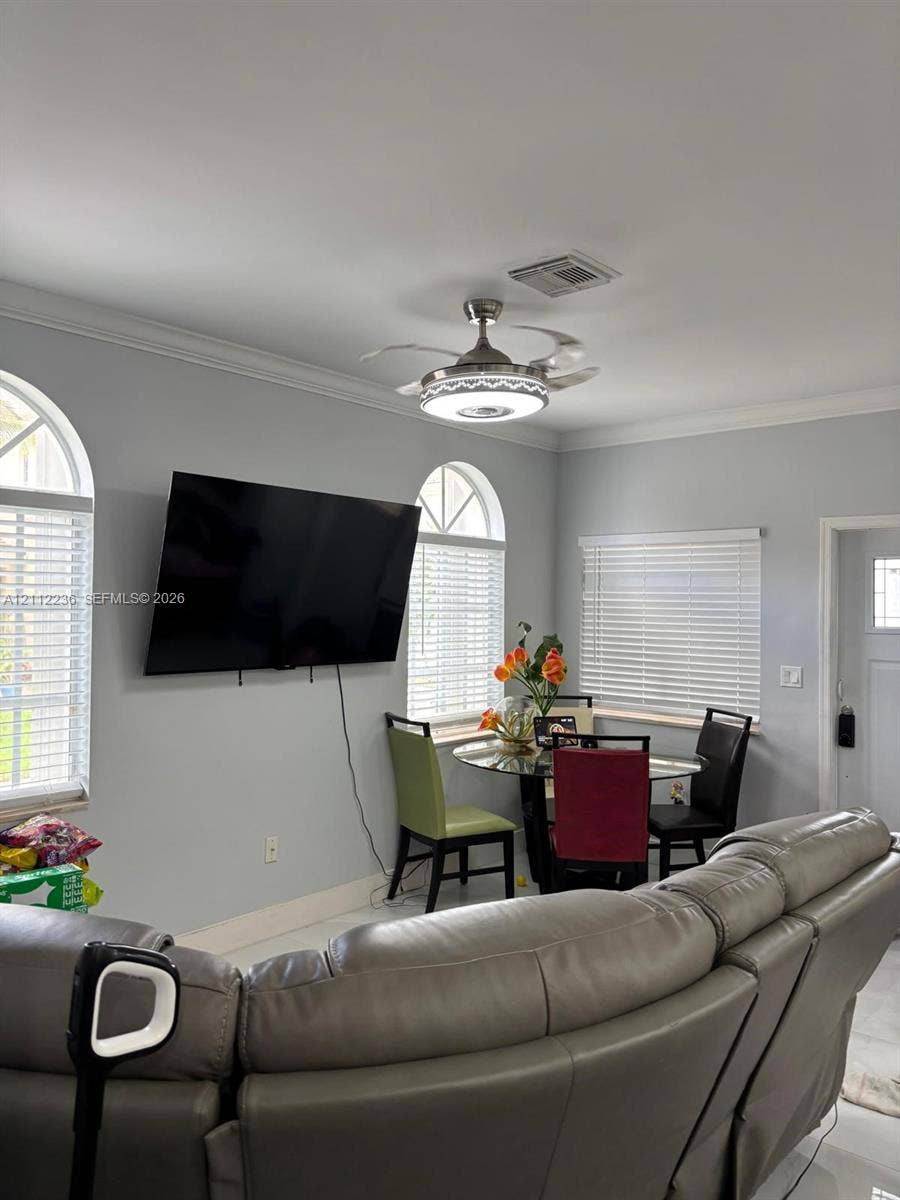 13946 SW 276th Street, #0, Homestead, FL 33032 Interior room featuring arched windows, horizontal blinds, and a retractable blade ceiling fan with integrated lighting