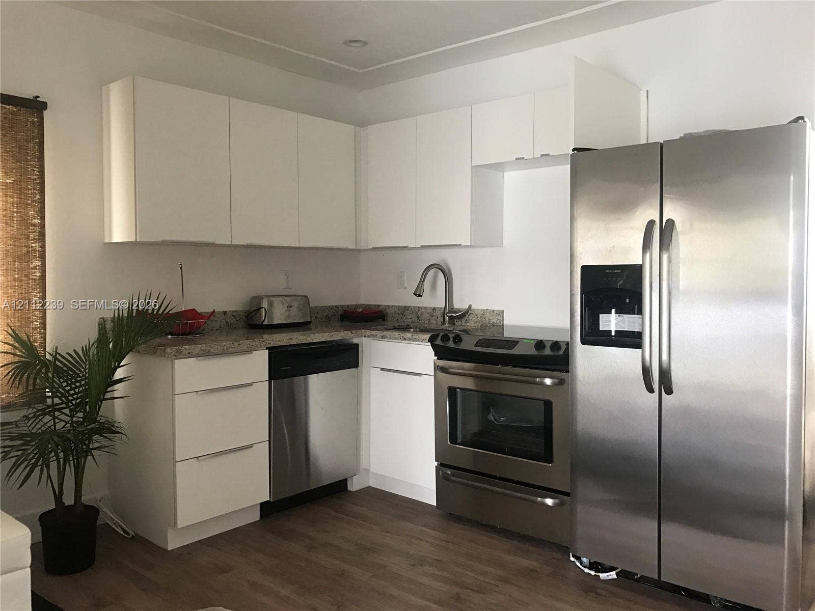 260 NW 40th Street, #S, Miami, Miami, FL 33127 Kitchen featuring white flat-panel cabinetry, stone countertops, stainless steel appliances, and wood-finish flooring