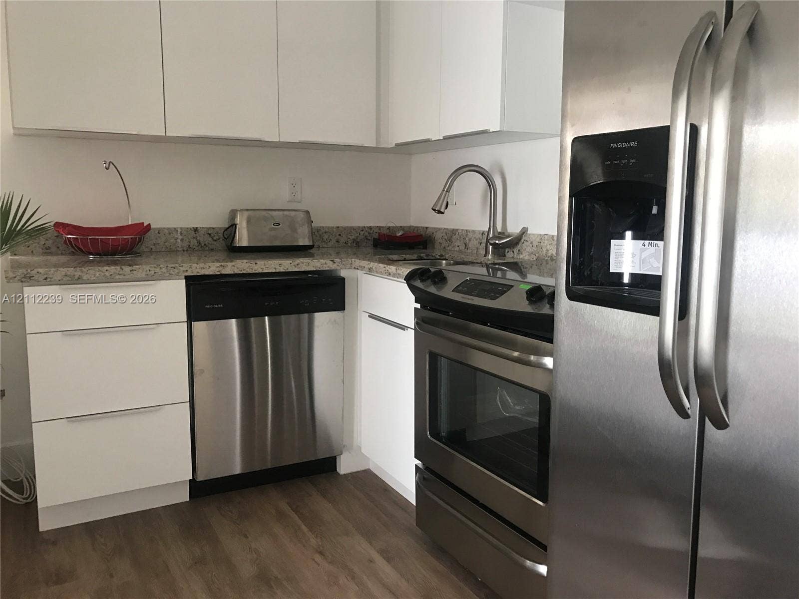 260 NW 40th Street, #S, Miami, Miami, FL 33127 Kitchen featuring white flat-panel cabinetry, stone countertops, stainless steel appliances, and wood-finish flooring