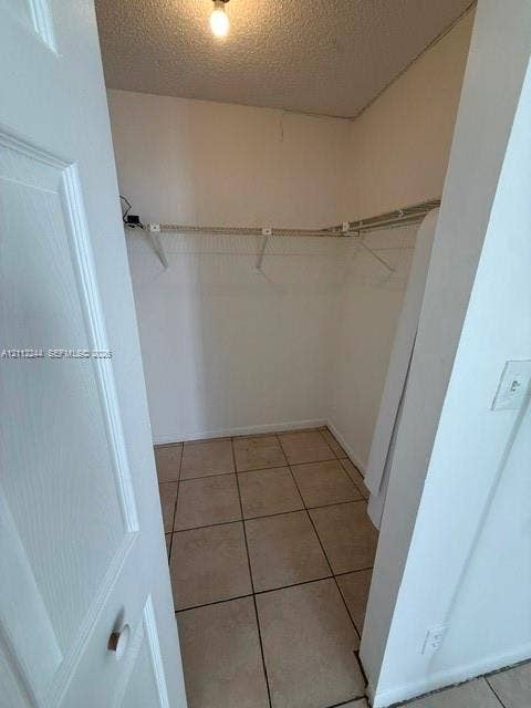 17011 N Bay Road, #415, Sunny Isles Beach, Sunny Isles Beach, FL 33160 Walk-in storage space featuring ceramic tile flooring, neutral-toned walls, and installed wire shelving
