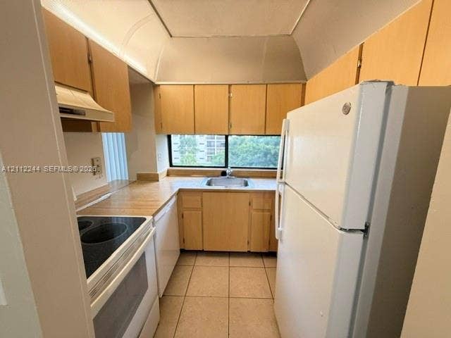 17011 N Bay Road, #415, Sunny Isles Beach, Sunny Isles Beach, FL 33160 Kitchen featuring light-finish cabinetry, solid-surface countertops, tile flooring, and a window above the undermount stainless steel sink