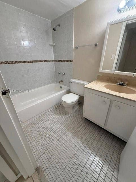 17011 N Bay Road, #415, Sunny Isles Beach, Sunny Isles Beach, FL 33160 Bathroom featuring a vanity with a stone-top integrated sink, a full-width medicine cabinet, a shower and tub combination with decorative tile inlay, and mosaic floor tiling