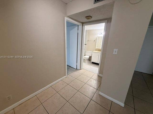 17011 N Bay Road, #415, Sunny Isles Beach, Sunny Isles Beach, FL 33160 Neutral tile flooring, interior doors with white trim, and a built-in bathroom vanity with a basin sink