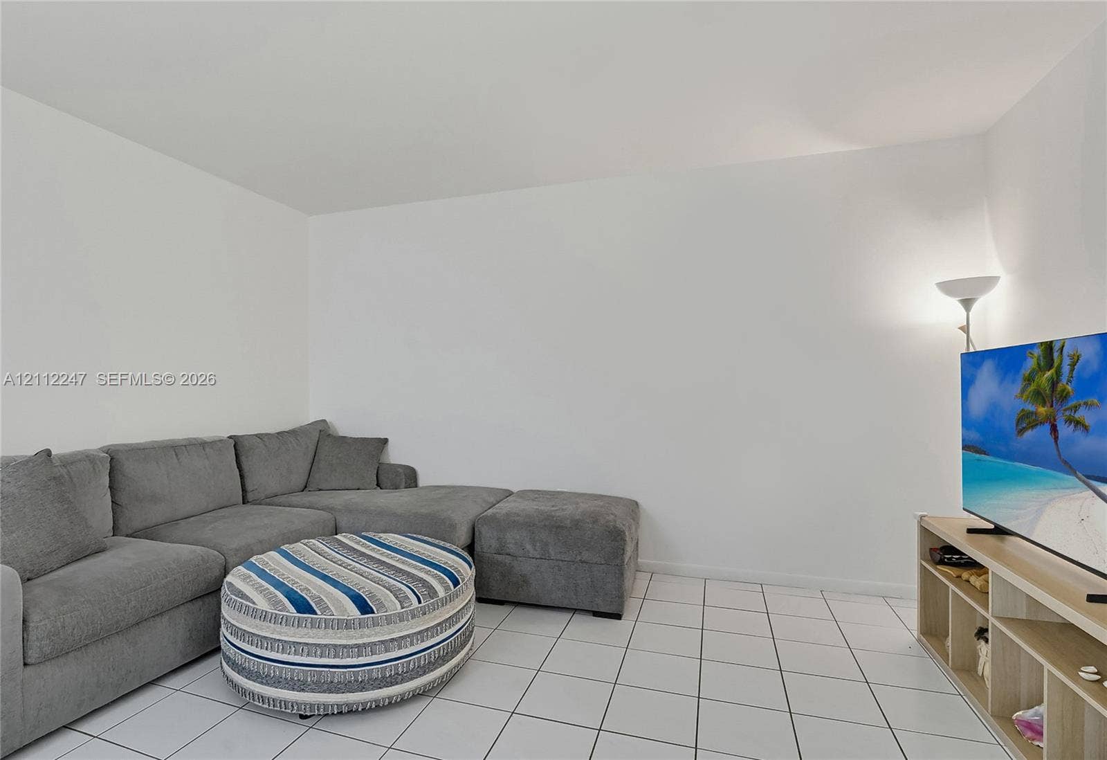 Neutral white wall finishes and ceramic tile flooring