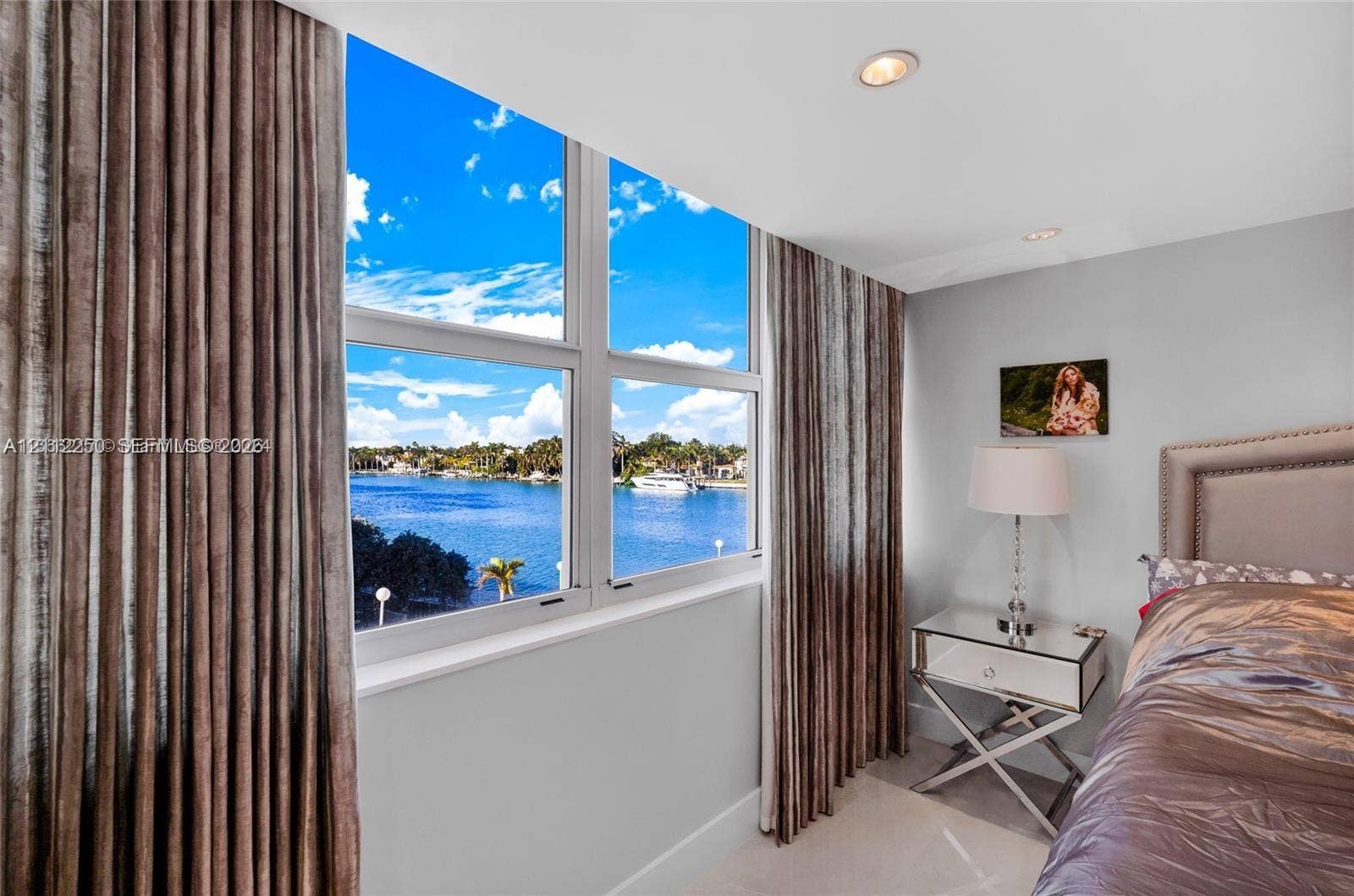 5838 Collins Avenue, #2F, Miami Beach, FL 33140 Large-format windows with multi-pane aluminum frames, recessed ceiling lighting, and expansive water exposure