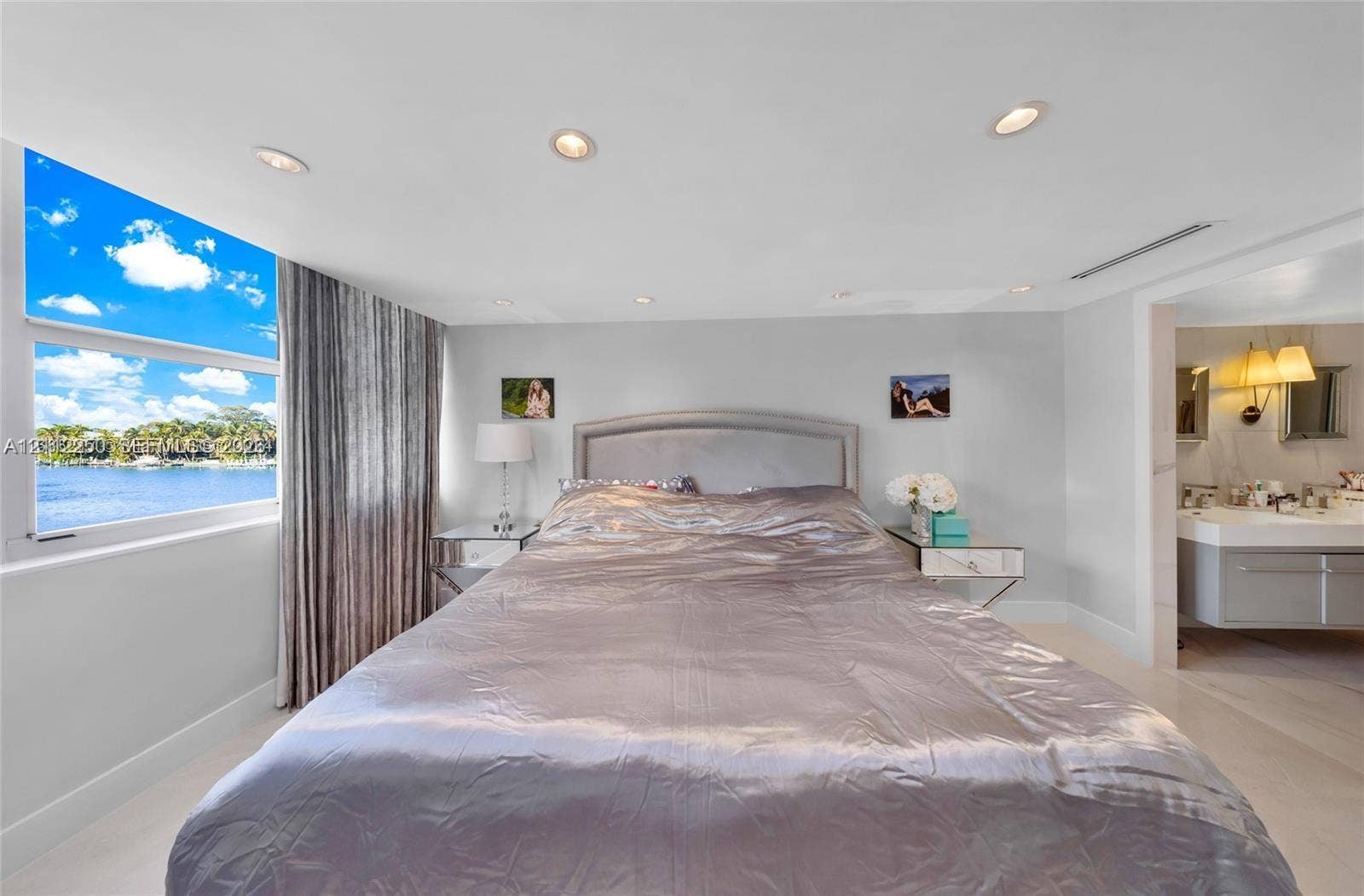 5838 Collins Avenue, #2F, Miami Beach, FL 33140 Waterfront exposure with expansive window, recessed ceiling lighting, and attached floating vanity with dual sinks