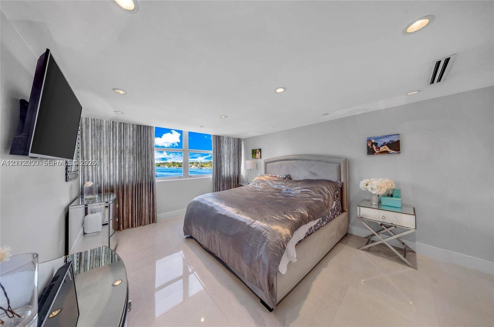 5838 Collins Avenue, #2F, Miami Beach, FL 33140 Large-format windows with water scenery, recessed ceiling lighting, and polished stone-finish flooring