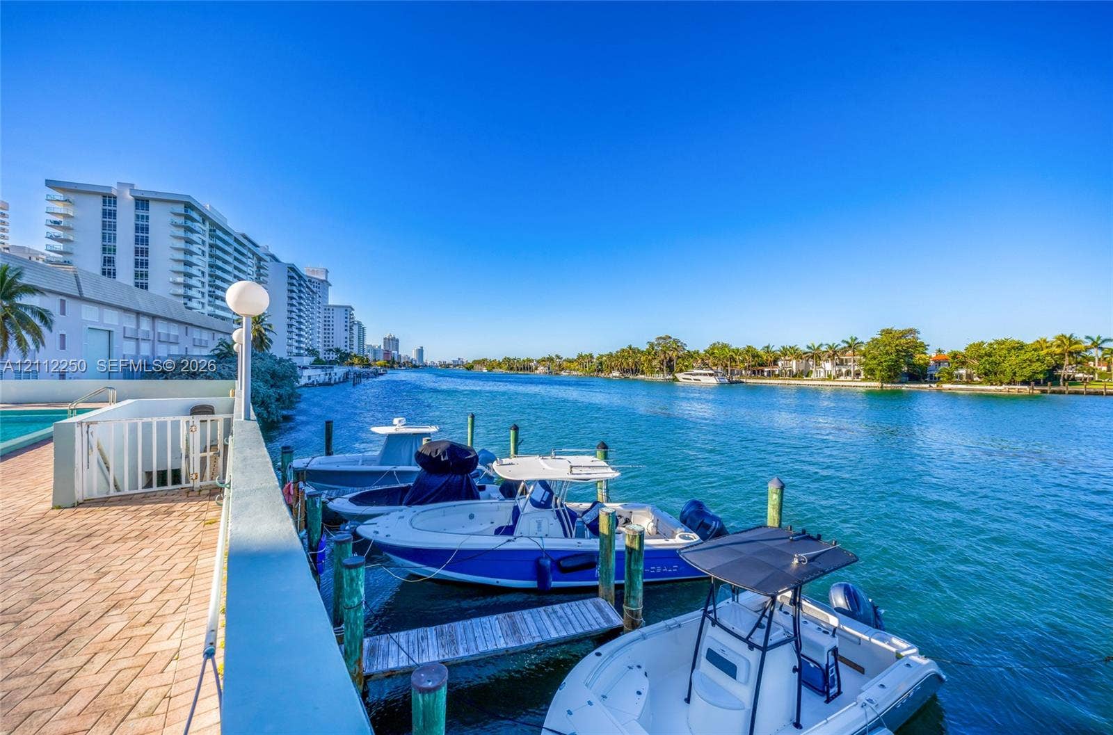 5838 Collins Avenue, #2F, Miami Beach, FL 33140 Waterfront bulkhead with brick-paver decking, private dock pilings, and direct deep-water access