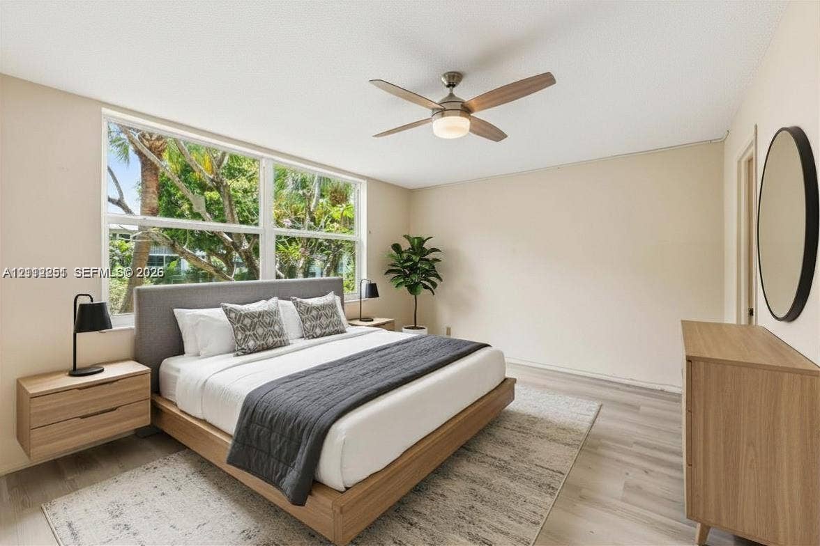 4025 N Federal Highway, #226C, Oakland Park, FL 33308 Wood-finish flooring, oversized picture windows, and a ceiling fan with integrated lighting
