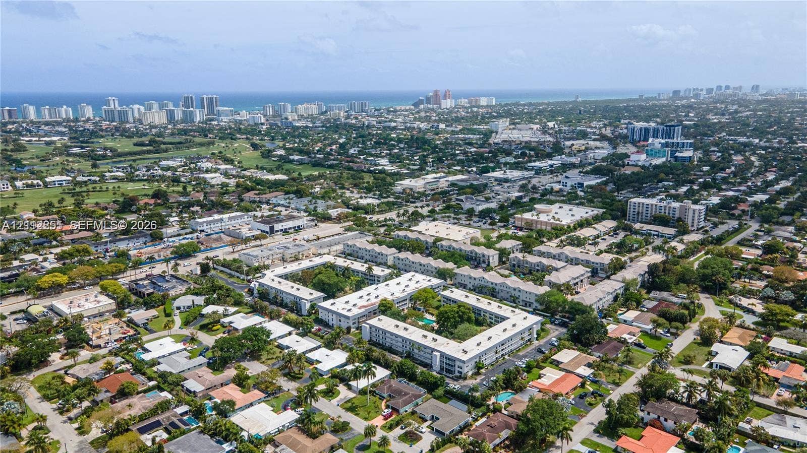 4025 N Federal Highway, #226C, Oakland Park, FL 33308 Aerial perspective featuring proximity to the Atlantic coastline, expansive urban surroundings, and mature palm tree canopy