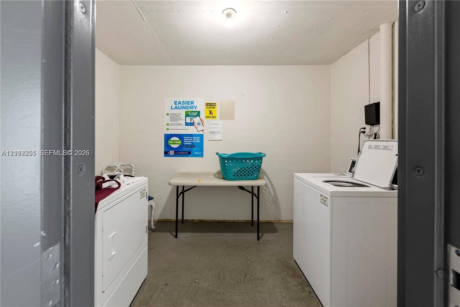 4025 N Federal Highway, #226C, Oakland Park, FL 33308 Dedicated laundry area featuring solid-surface flooring, neutral wall finishes, and overhead lighting