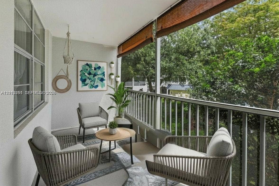 4025 N Federal Highway, #226C, Oakland Park, FL 33308 Screened balcony featuring a white metal railing, roll-up bamboo shade, and large-format tile flooring