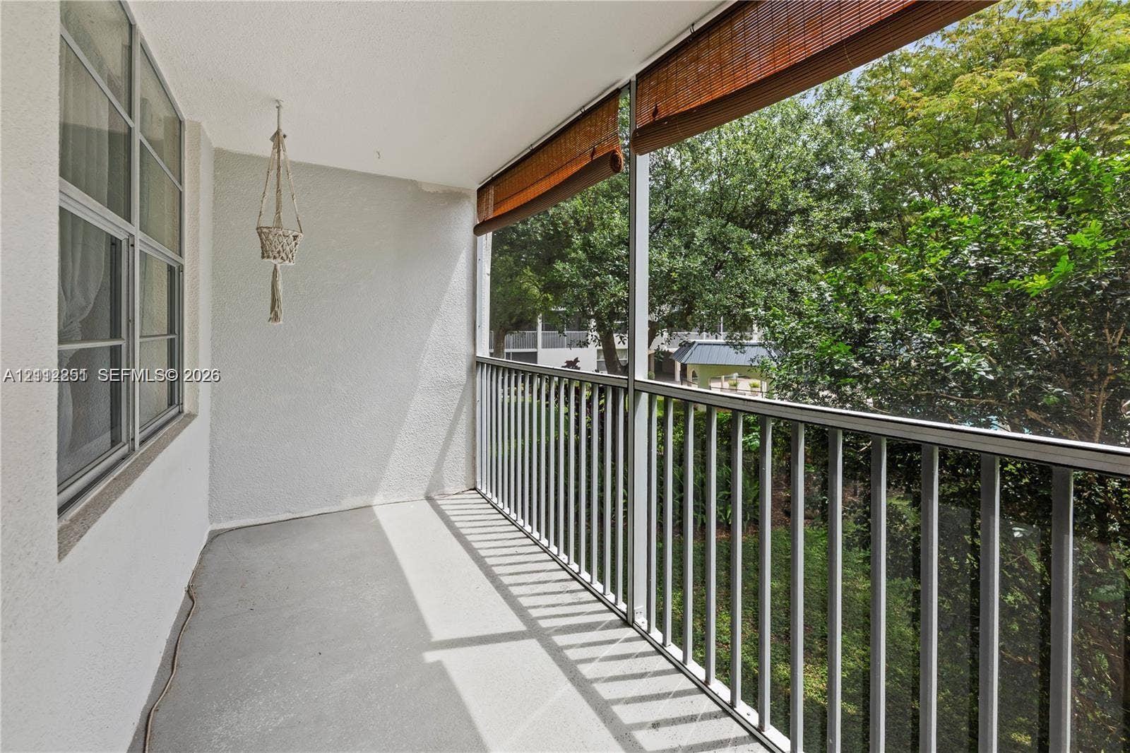 4025 N Federal Highway, #226C, Oakland Park, FL 33308 Screened-in balcony featuring concrete flooring, metal railing, and roll-down sun shades