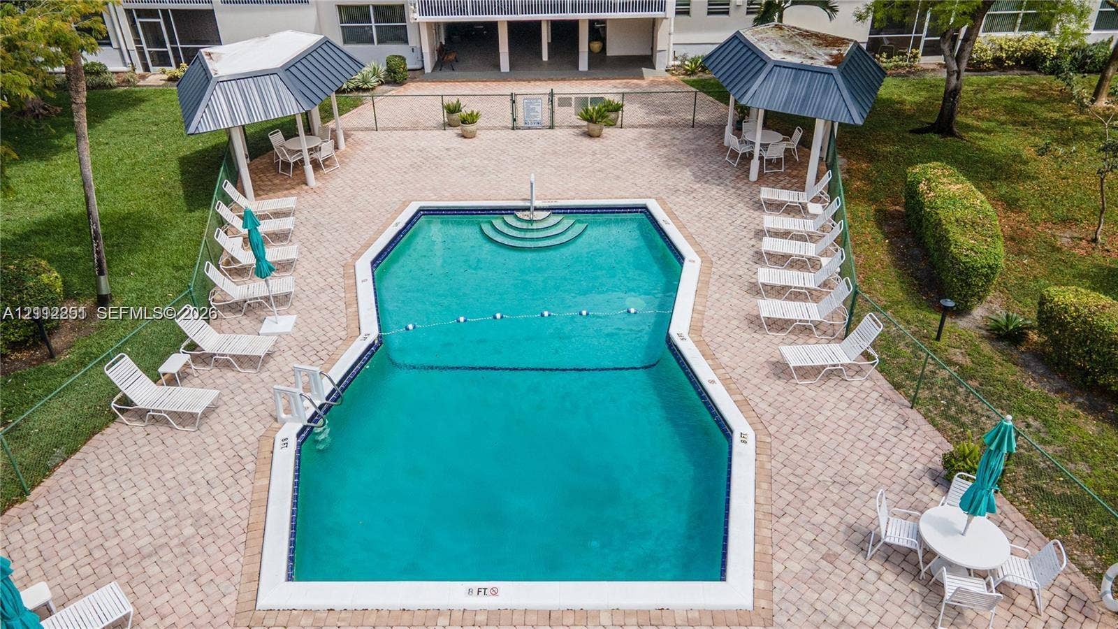 4025 N Federal Highway, #226C, Oakland Park, FL 33308 Community pool featuring paved decking, metal-roofed cabanas, and integrated stair entry