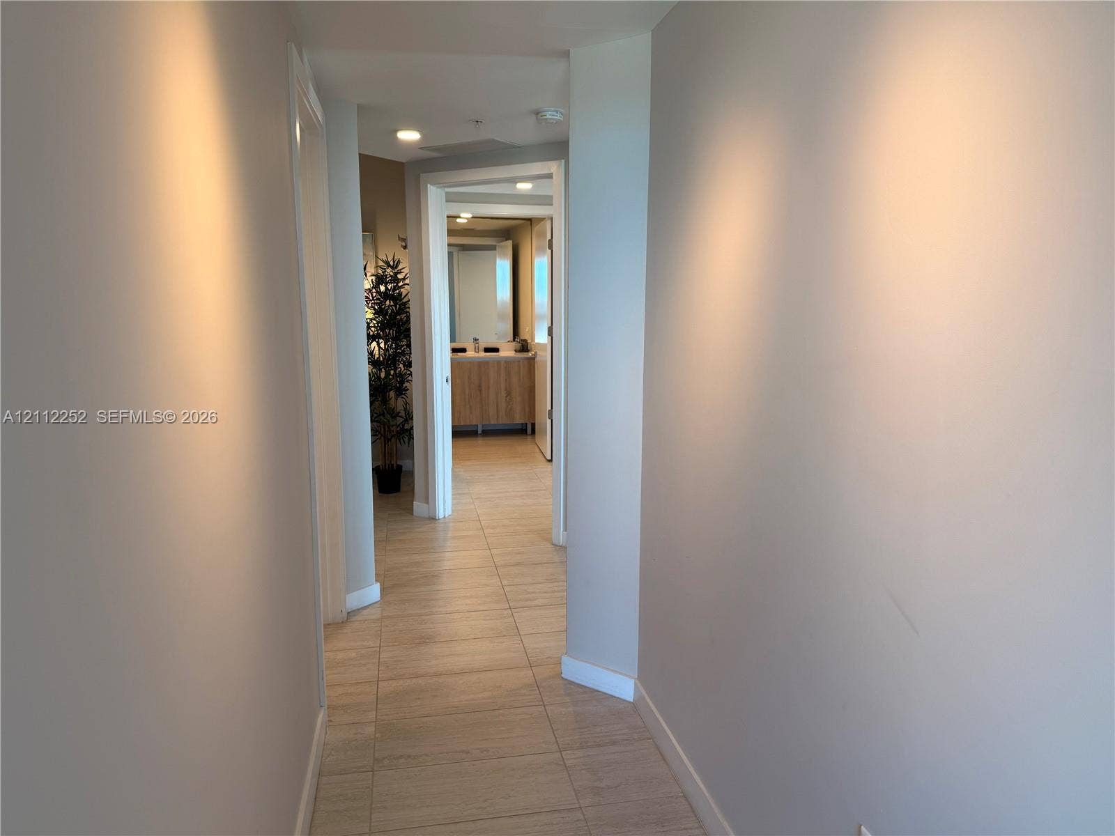 3900 Biscayne Boulevard, #N-1113, Miami, FL 33137 Hallway featuring neutral-toned wall paint, large-format tile flooring, and recessed ceiling lighting