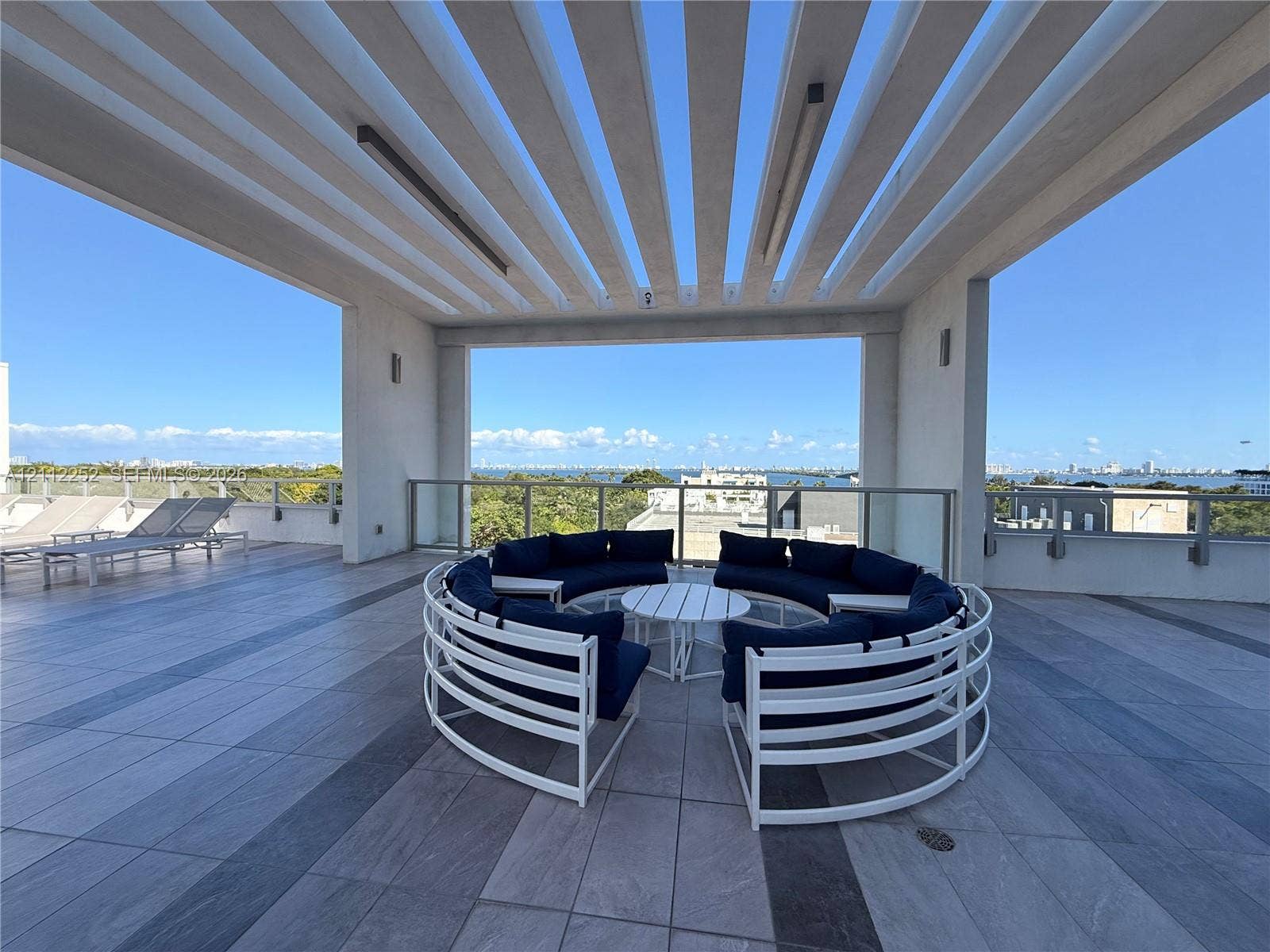 3900 Biscayne Boulevard, #N-1113, Miami, FL 33137 Expansive rooftop terrace featuring a structural pergola, large-format tile flooring, and glass railing enclosures