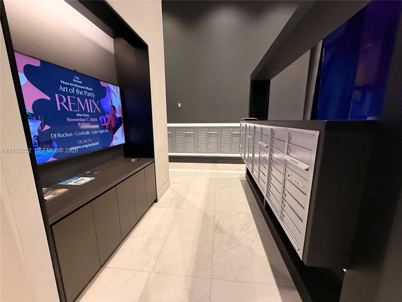 3900 Biscayne Boulevard, #N-1113, Miami, FL 33137 Mail center featuring integrated metallic mailboxes, built-in matte black cabinetry, and large-format tile flooring