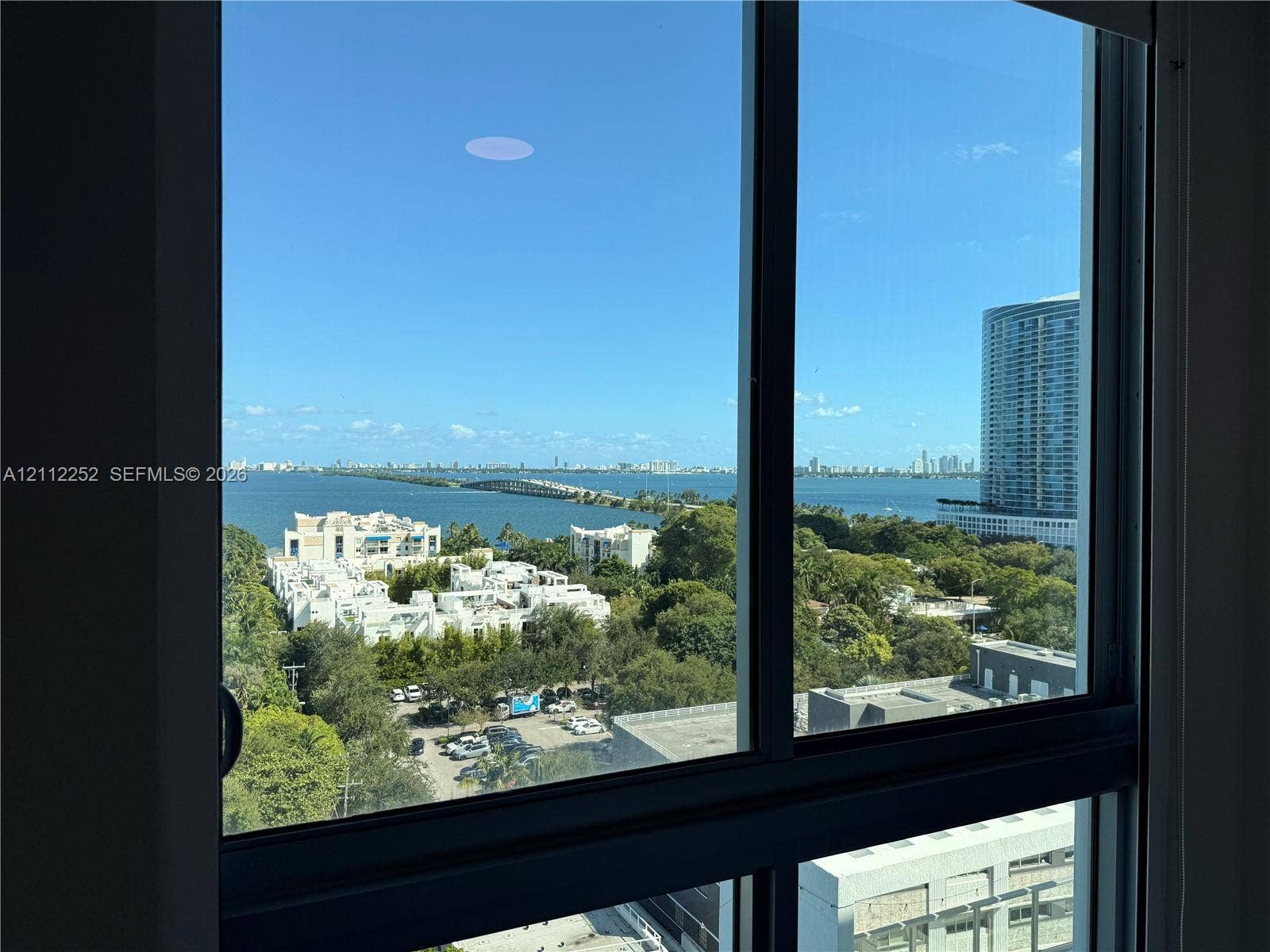 3900 Biscayne Boulevard, #N-1113, Miami, FL 33137 Floor-to-ceiling windows with expansive water and metropolitan skyline backdrop
