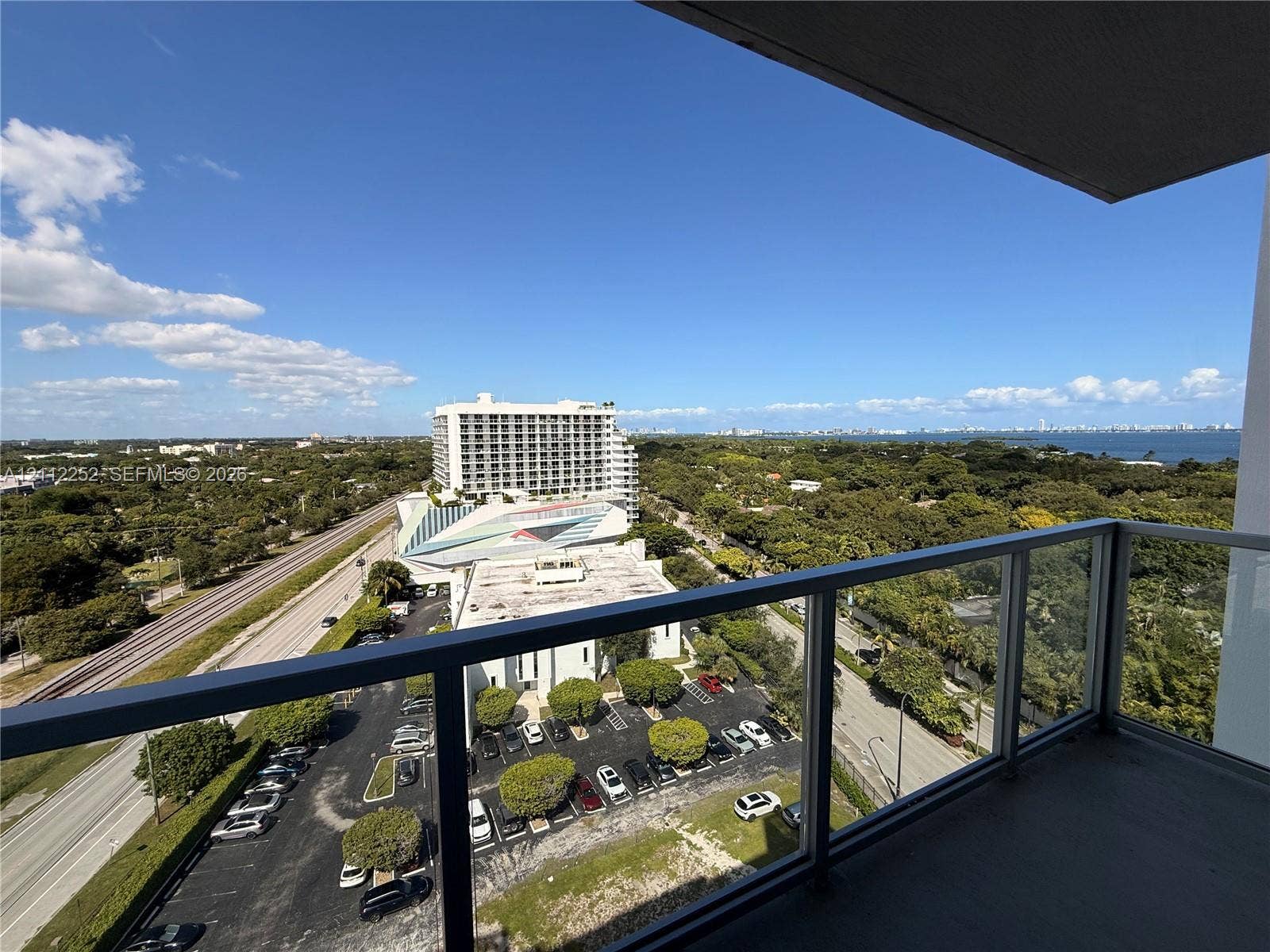 3900 Biscayne Boulevard, #N-1113, Miami, FL 33137 Covered balcony featuring glass railing and concrete flooring