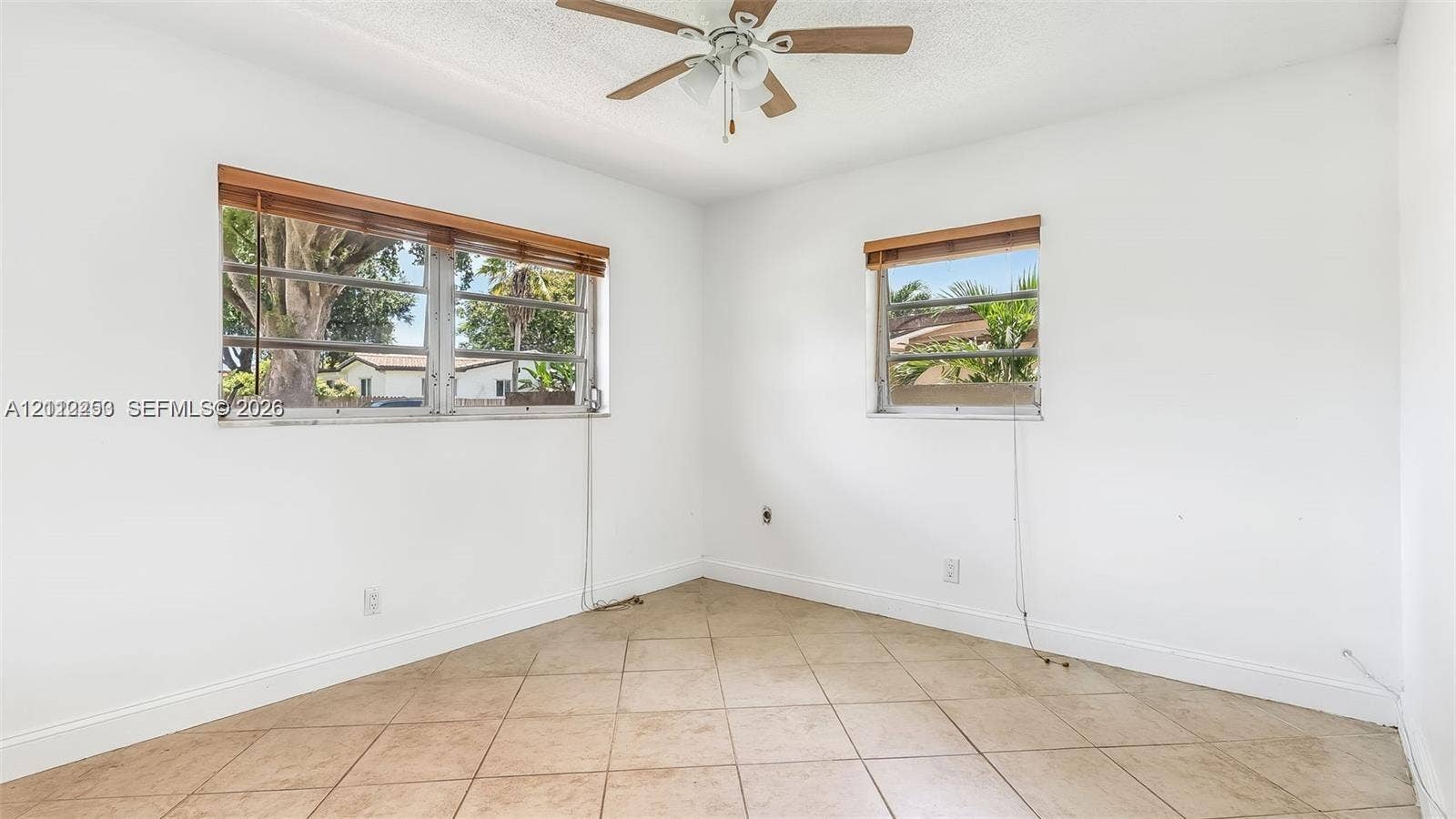500 NW 96th Terrace, Pembroke Pines, FL 33024 Neutral wall finish, ceramic tile flooring, ceiling fan with light fixture, and horizontal window treatments