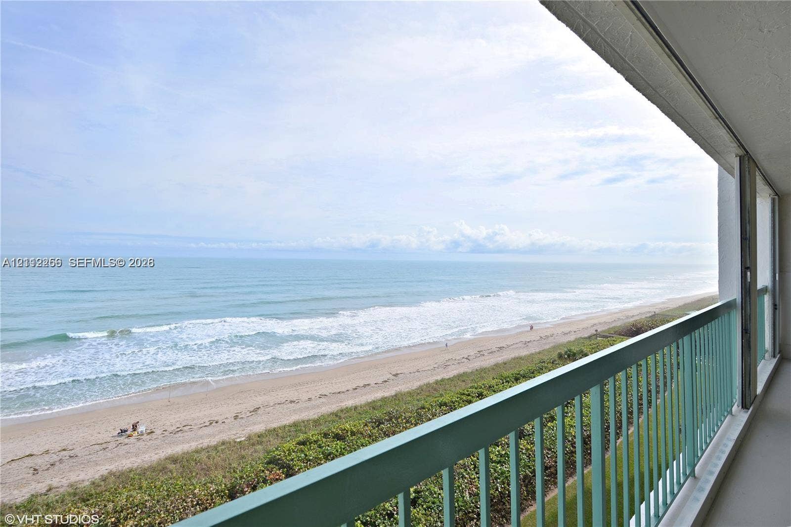 9900 S Ocean Drive, #601, Jensen Beach, FL 34957 Covered balcony with a protective metal railing, featuring direct exposure to the ocean coastline