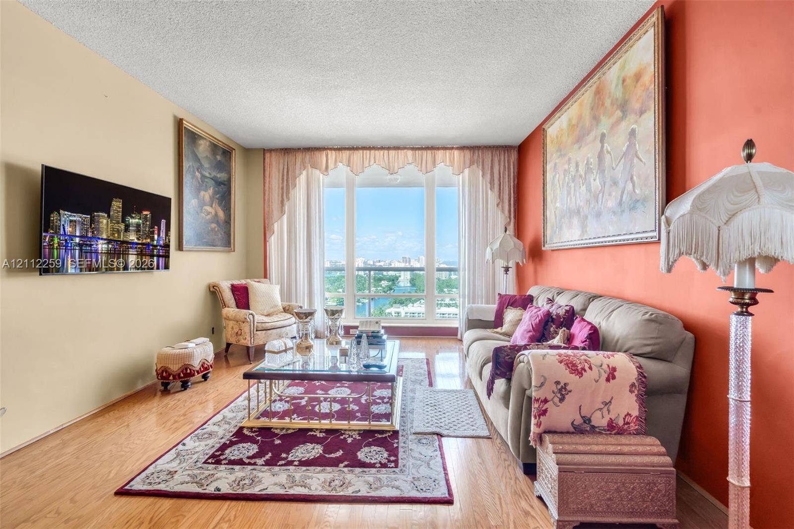 Living area featuring floor-to-ceiling windows and wood-finish flooring