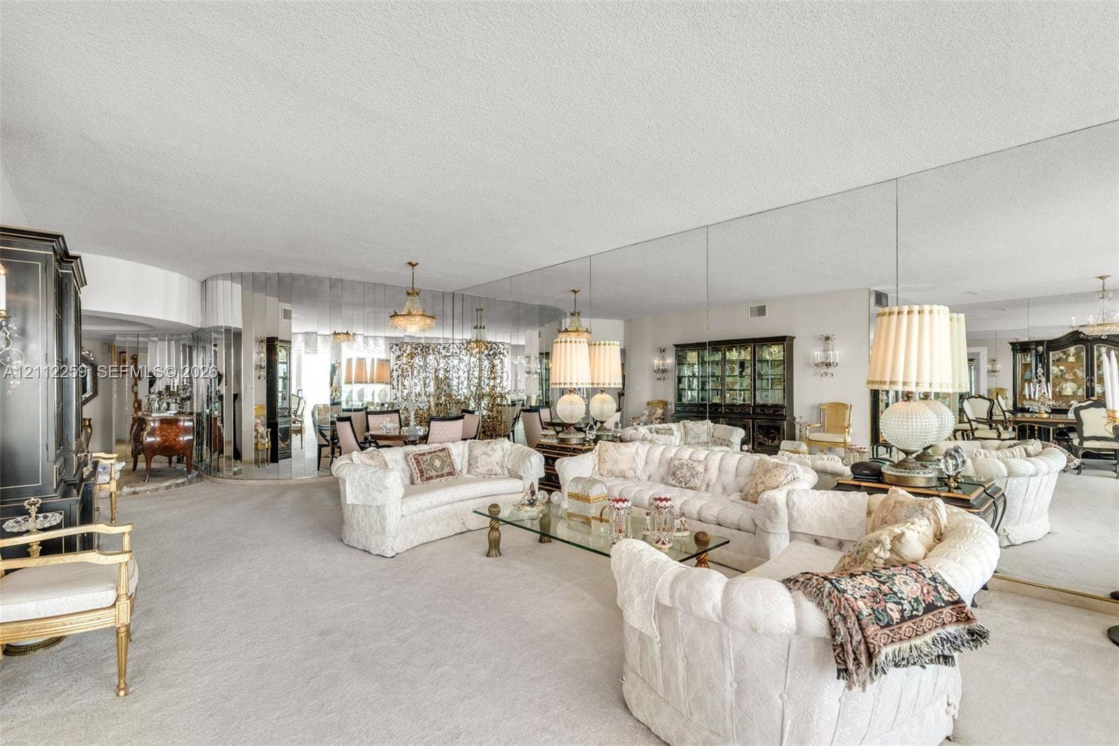 Expansive room featuring floor-to-ceiling wall mirrors and custom curved architectural detailing