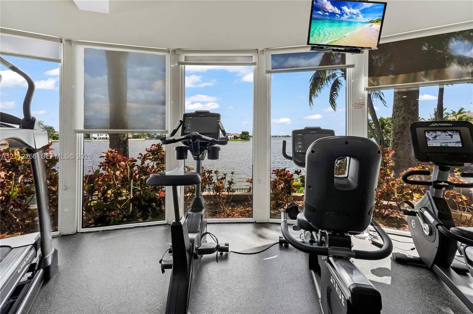Floor-to-ceiling windows, panoramic waterfront exposure, rubberized flooring, and motorized solar shades