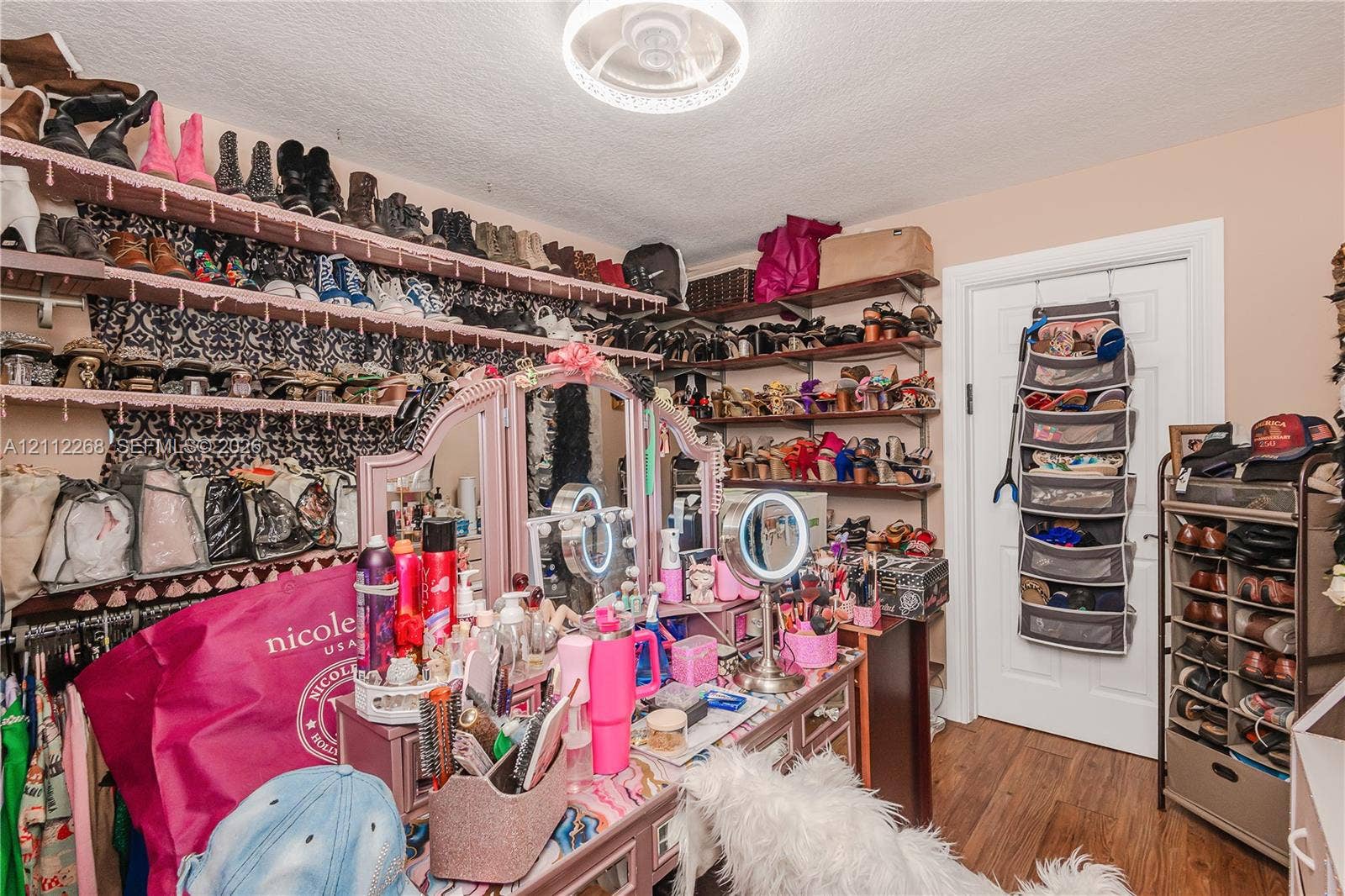 5941 SW 16th Court, Plantation, FL 33317 Walk-in closet featuring extensive wall-mounted shelving and wood-finish flooring