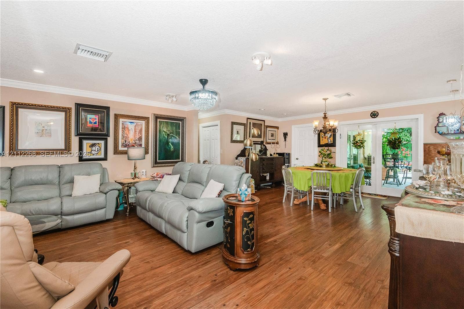 5941 SW 16th Court, Plantation, FL 33317 Wood-finish flooring, crown molding, multi-pane glass double doors, crystal-style chandelier, and recessed lighting