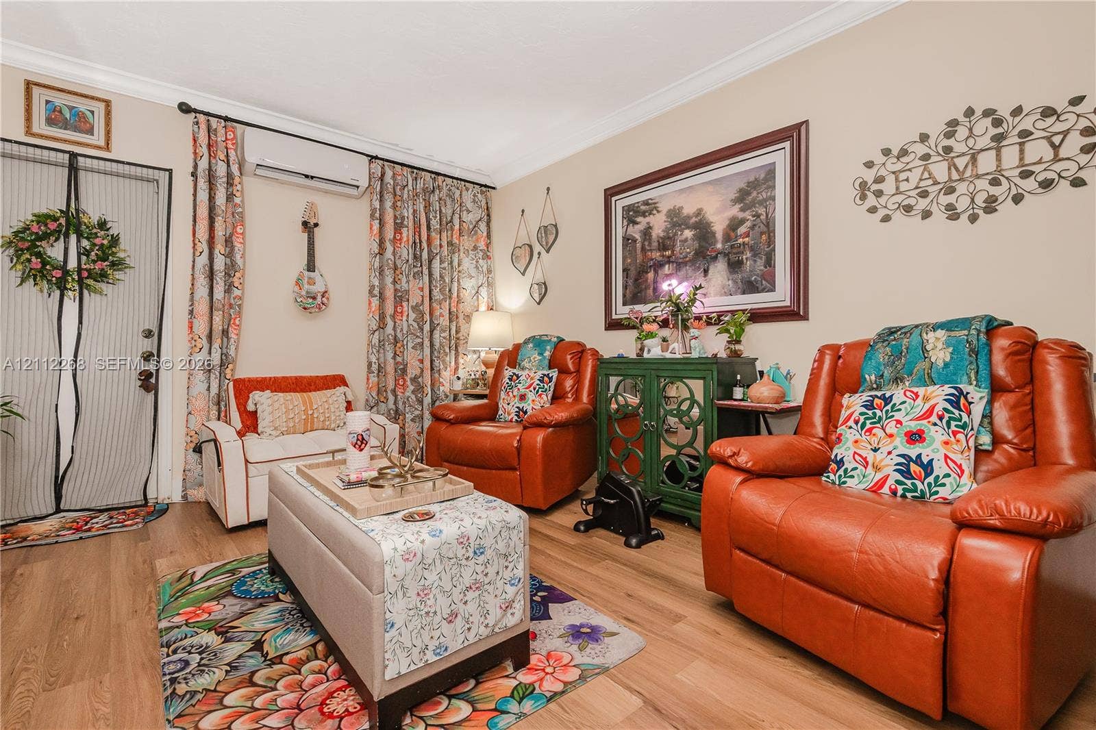 5941 SW 16th Court, Plantation, FL 33317 Wood-finish flooring, crown molding, and wall-mounted climate control unit