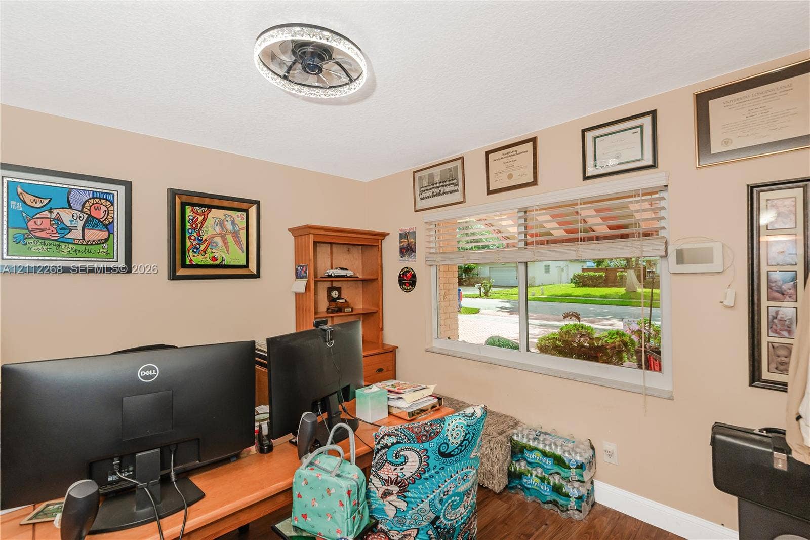 5941 SW 16th Court, Plantation, FL 33317 Room featuring a circular LED-integrated ceiling fixture, wood-finish flooring, and a large horizontal window with neutral blinds