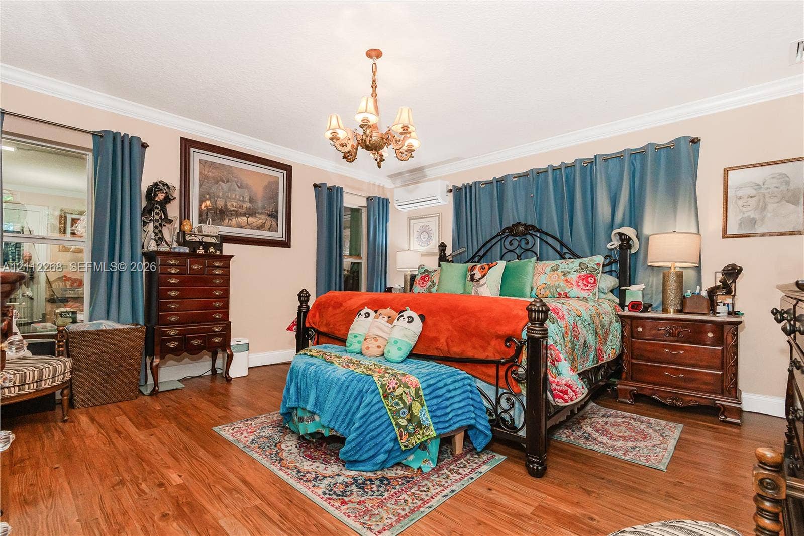 5941 SW 16th Court, Plantation, FL 33317 Room featuring wood-finish flooring, crown molding, a wall-mounted ductless mini-split HVAC unit, and a central decorative multi-arm chandelier