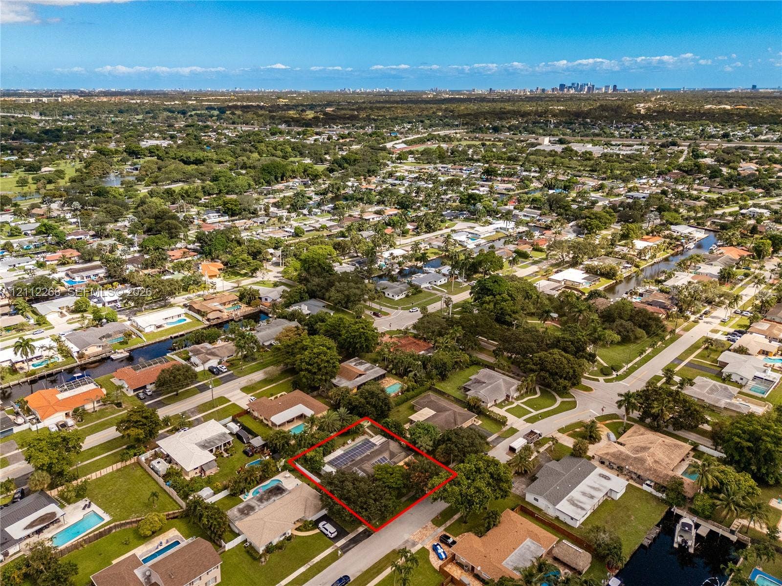 5941 SW 16th Court, Plantation, FL 33317 Aerial perspective featuring a residential lot with solar panel installation and established trees
