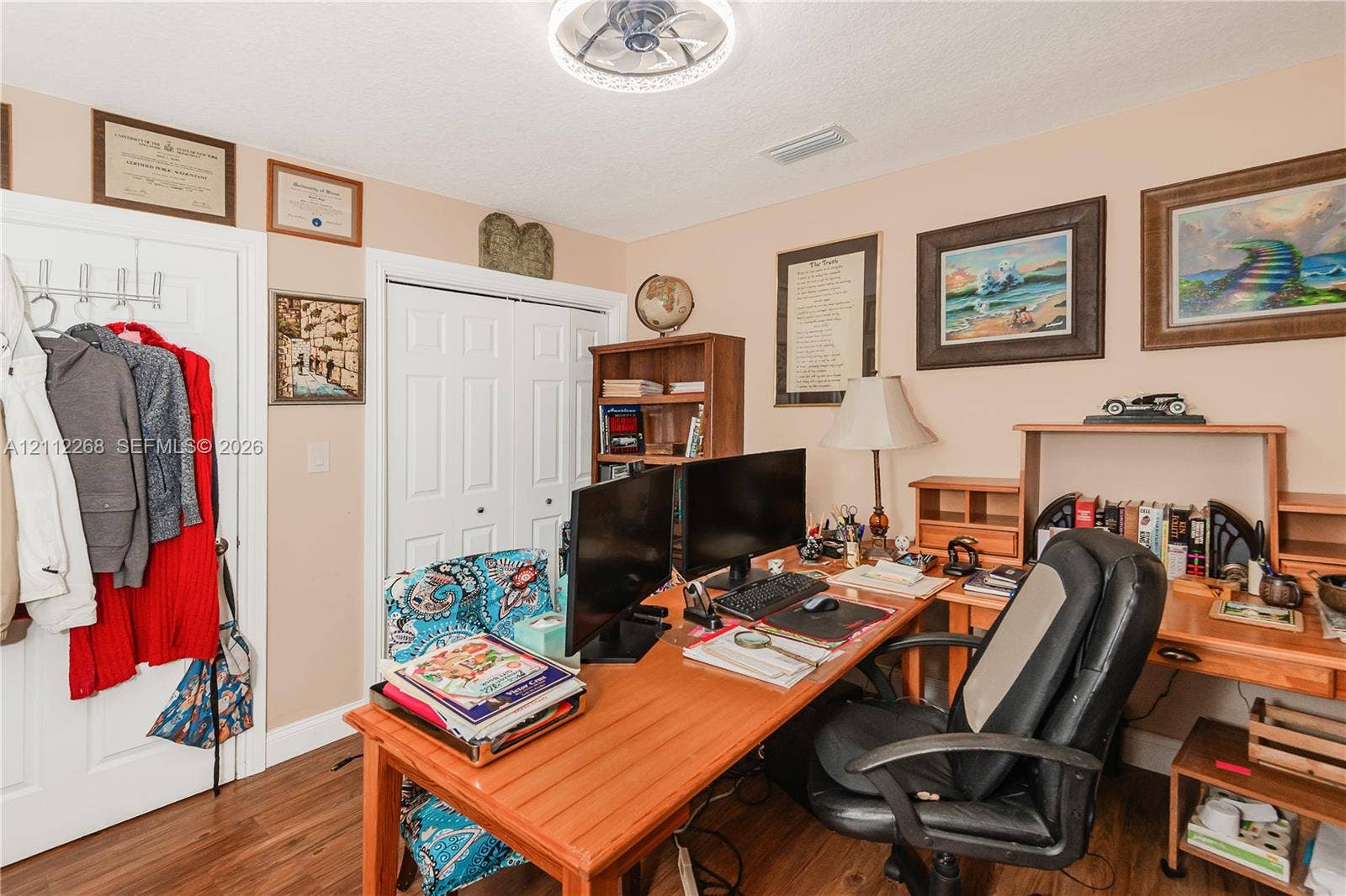 5941 SW 16th Court, Plantation, FL 33317 Room featuring wood-finish flooring, dual-panel closet doors, and a flush-mount ceiling light fixture