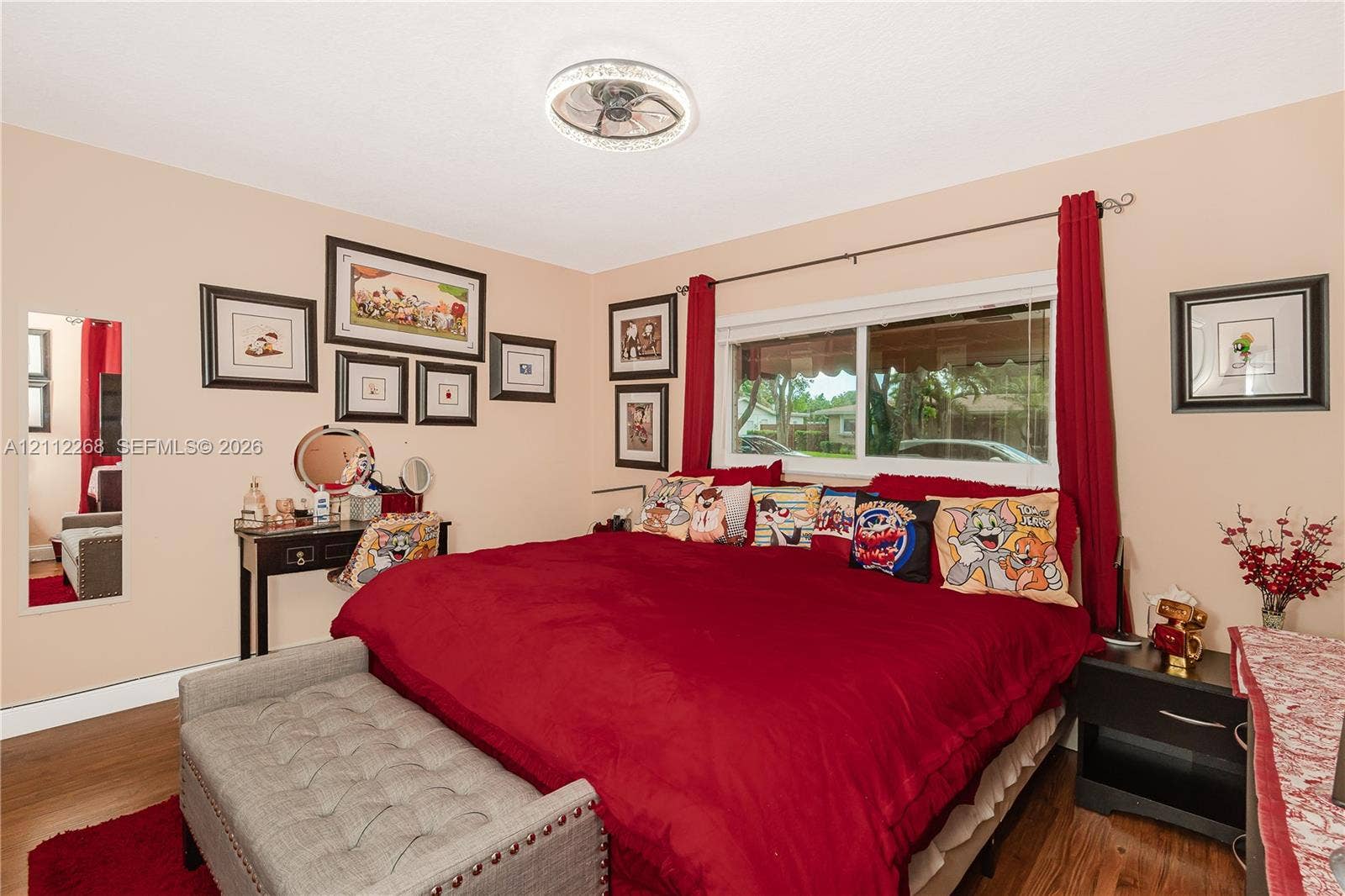 5941 SW 16th Court, Plantation, FL 33317 Room featuring wood-finish flooring, a ceiling-mounted light fixture with integrated fan, and a large horizontal sliding window