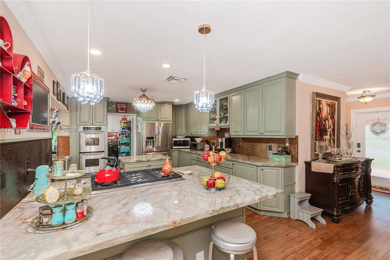 5941 SW 16th Court, Plantation, FL 33317 Kitchen featuring custom cabinetry, expansive stone countertops, a central island with a built-in gas cooktop, double wall ovens, and recessed lighting
