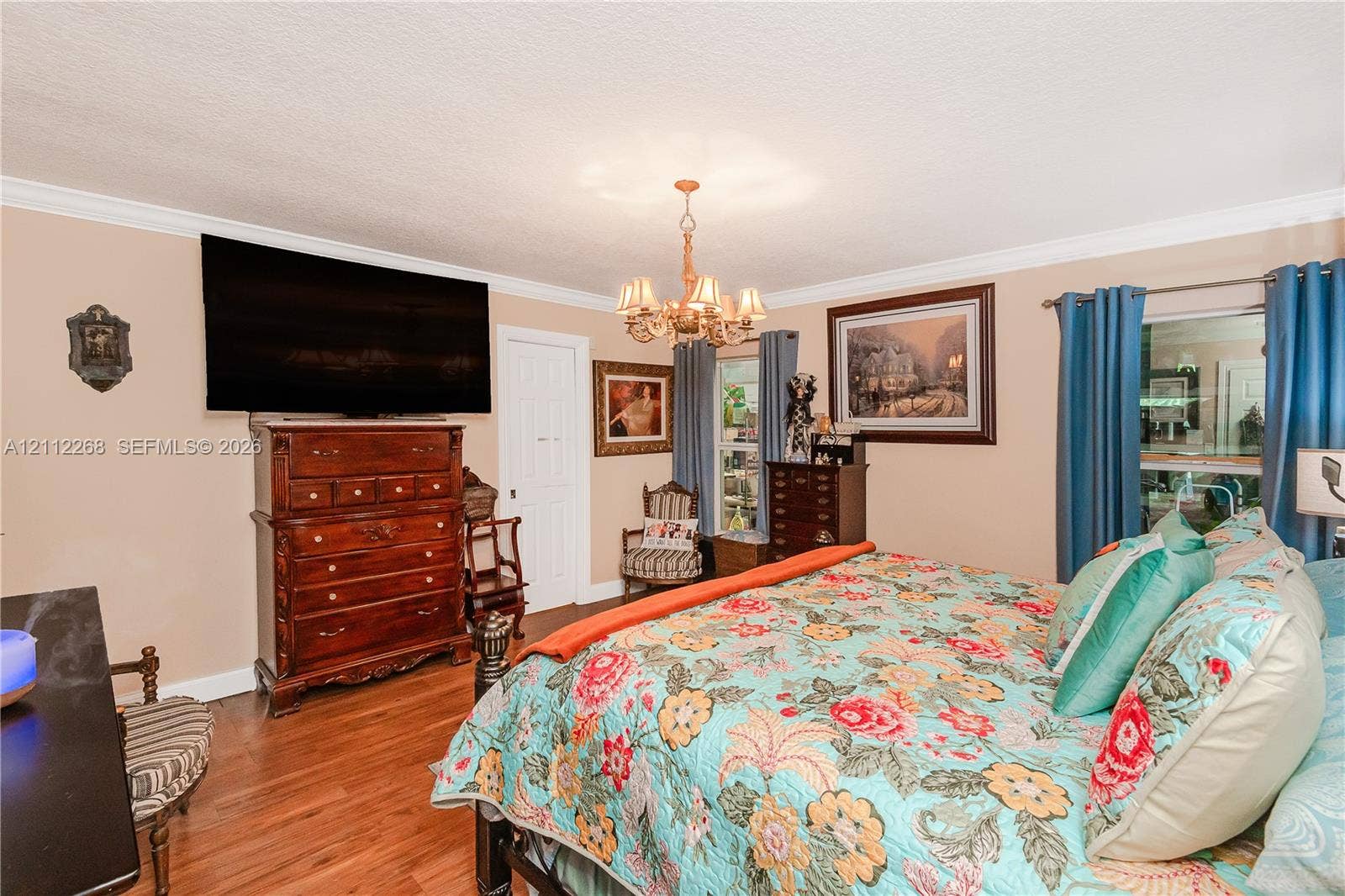 5941 SW 16th Court, Plantation, FL 33317 Wood-finish flooring, multi-arm metal chandelier, and crown molding