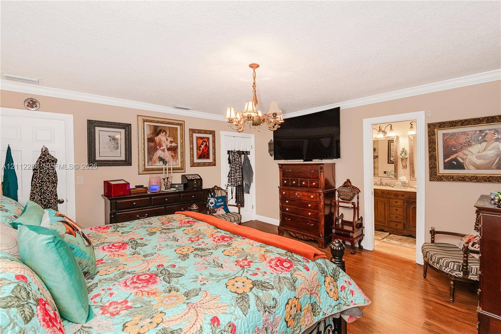 5941 SW 16th Court, Plantation, FL 33317 Room featuring wood-finish flooring, crown molding, and an ornate multi-arm chandelier