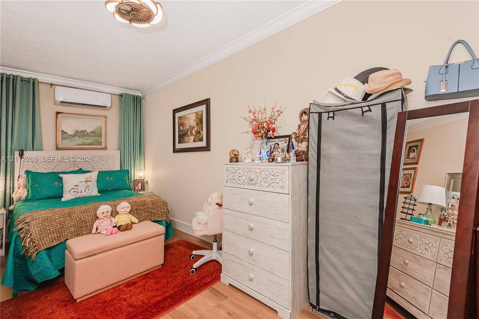 5941 SW 16th Court, Plantation, FL 33317 Interior space featuring crown molding, wood-finish flooring, a wall-mounted ductless climate control unit, and a decorative semi-flush mount ceiling fixture