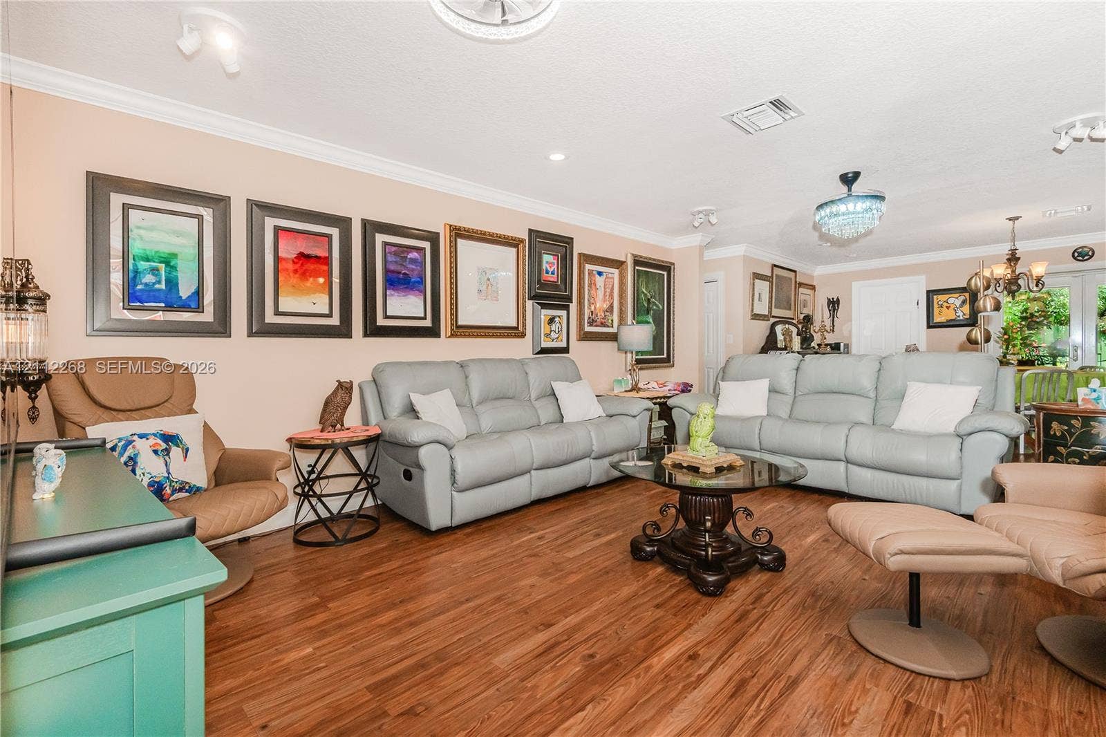 5941 SW 16th Court, Plantation, FL 33317 Wood-finish flooring, crown molding, and decorative ceiling-mounted light fixtures