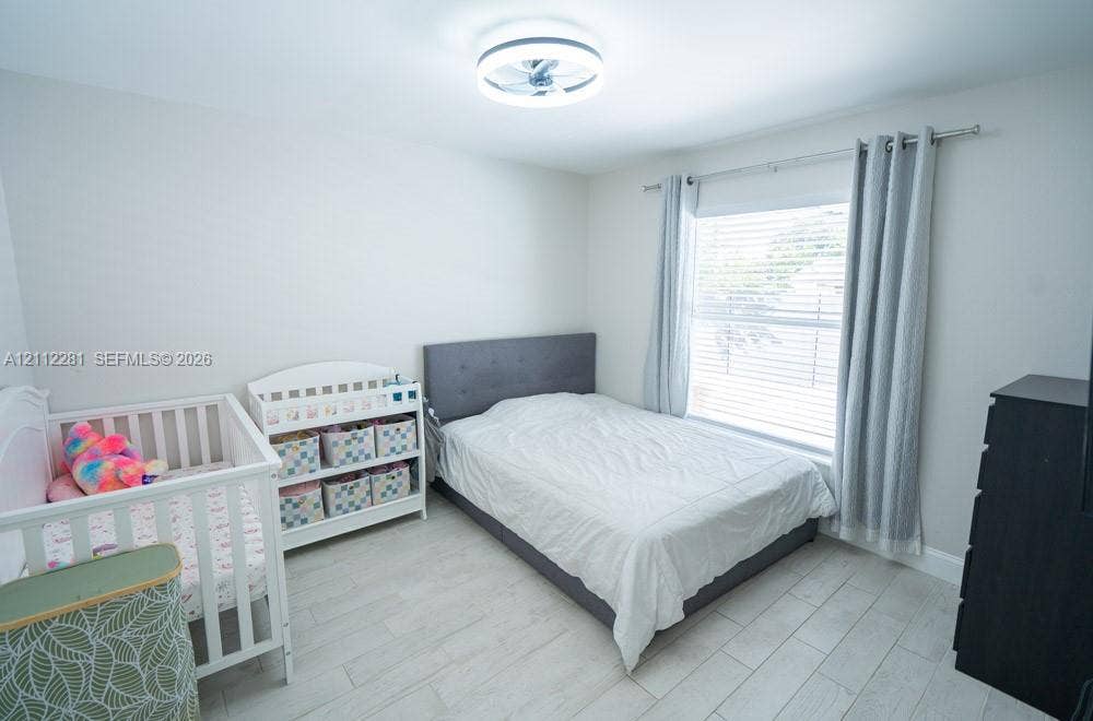 2461 Winfield, Kissimmee, FL 34743 Neutral-toned interior featuring wood-finish tile flooring, a recessed ceiling fan light fixture, and horizontal window blinds